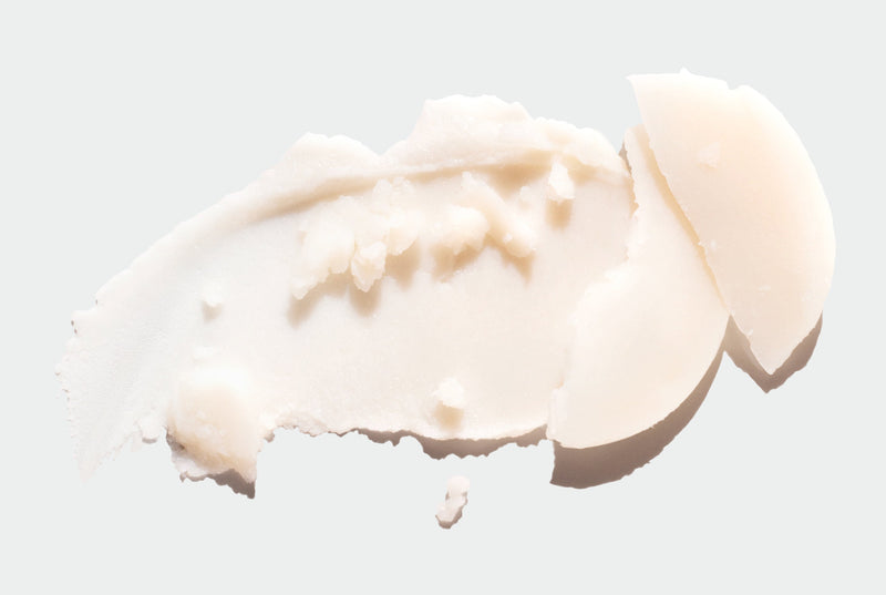 Close-up of a smear of beige Forest Fix Deodorant a light gray background